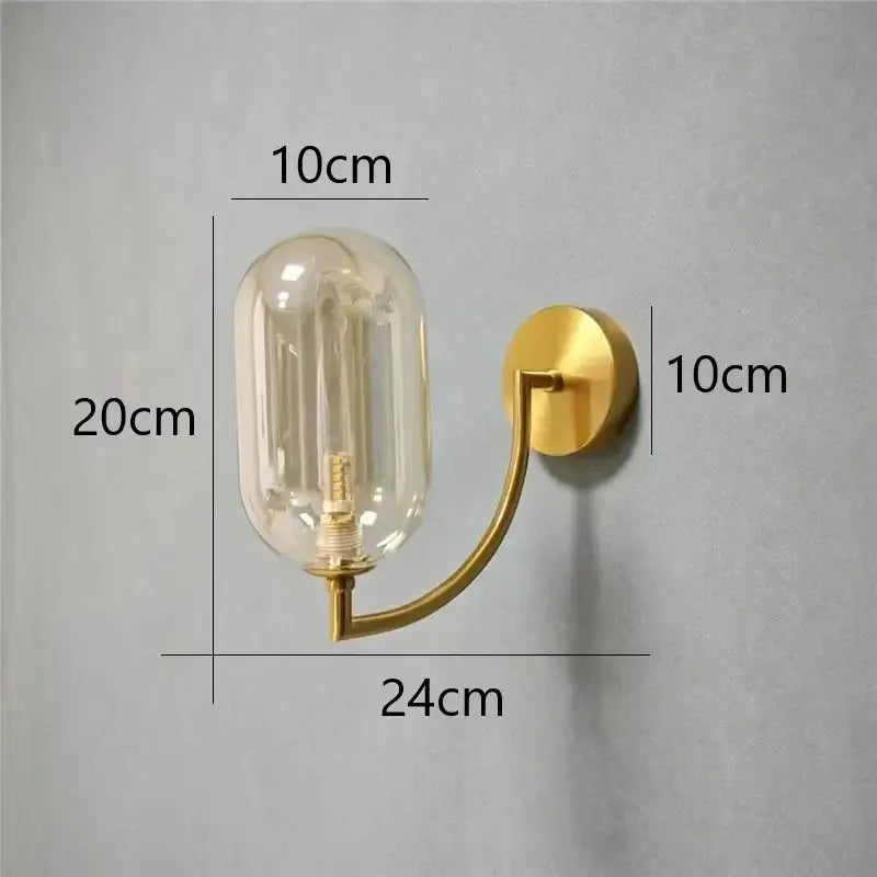 Minimalist gold glass ball wall sconce with curved arm and amber-tinted glass wall lamp for bedroom use