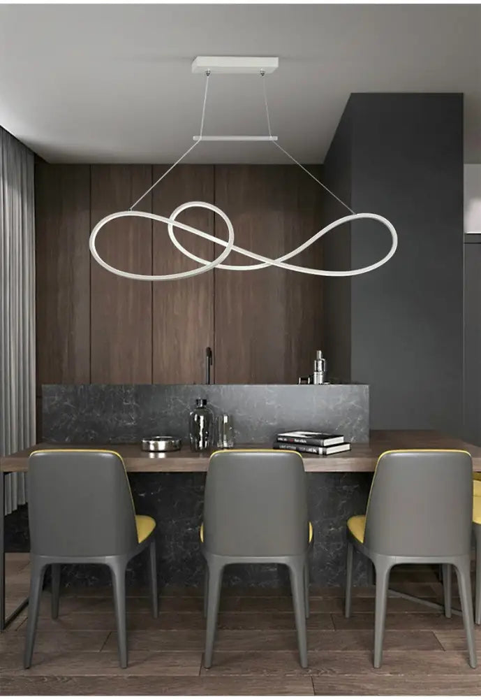 Minimalist gold infinity led strip island light with sleek white metal dining room pendant above table