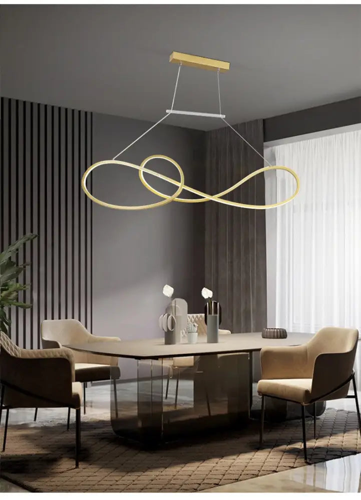 Gold-toned minimalist metal dining infinity led strip island light with sleek modern design above dining table