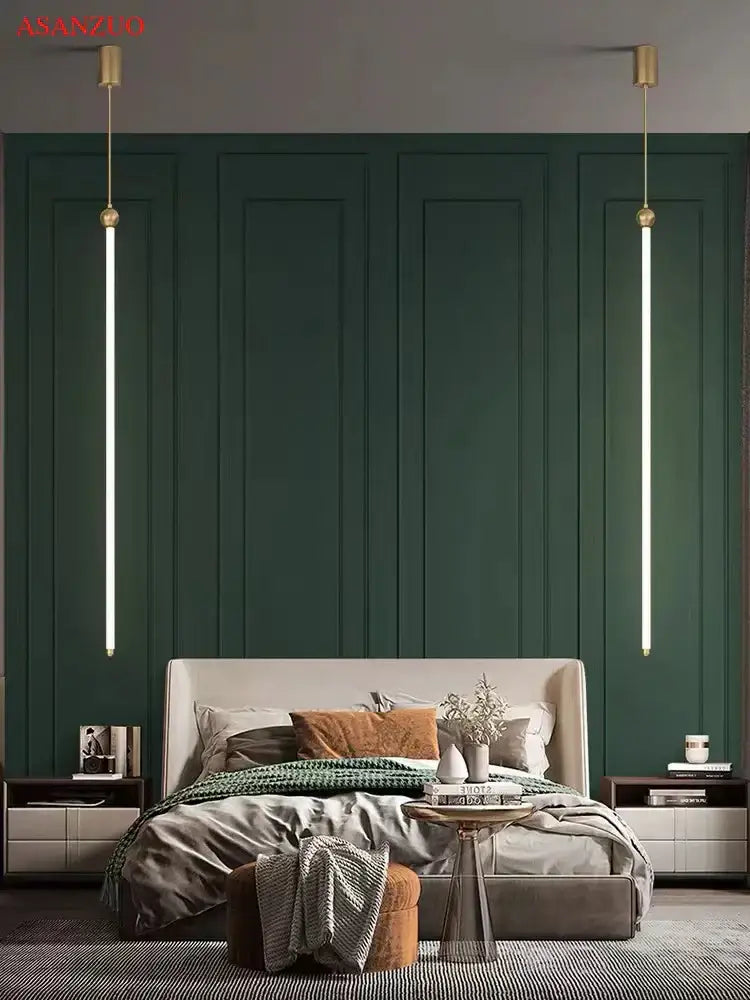 Minimalist gold led strip pendant lights hanging symmetrically over a deep emerald green paneled wall and modern bed decorbites led strip