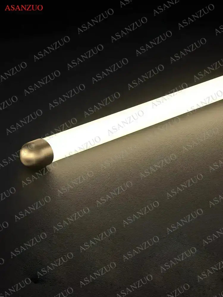 A minimalist gold led strip pendant light with a sleek illuminated fluorescent tube and metallic end cap for dining room decorbites led strip