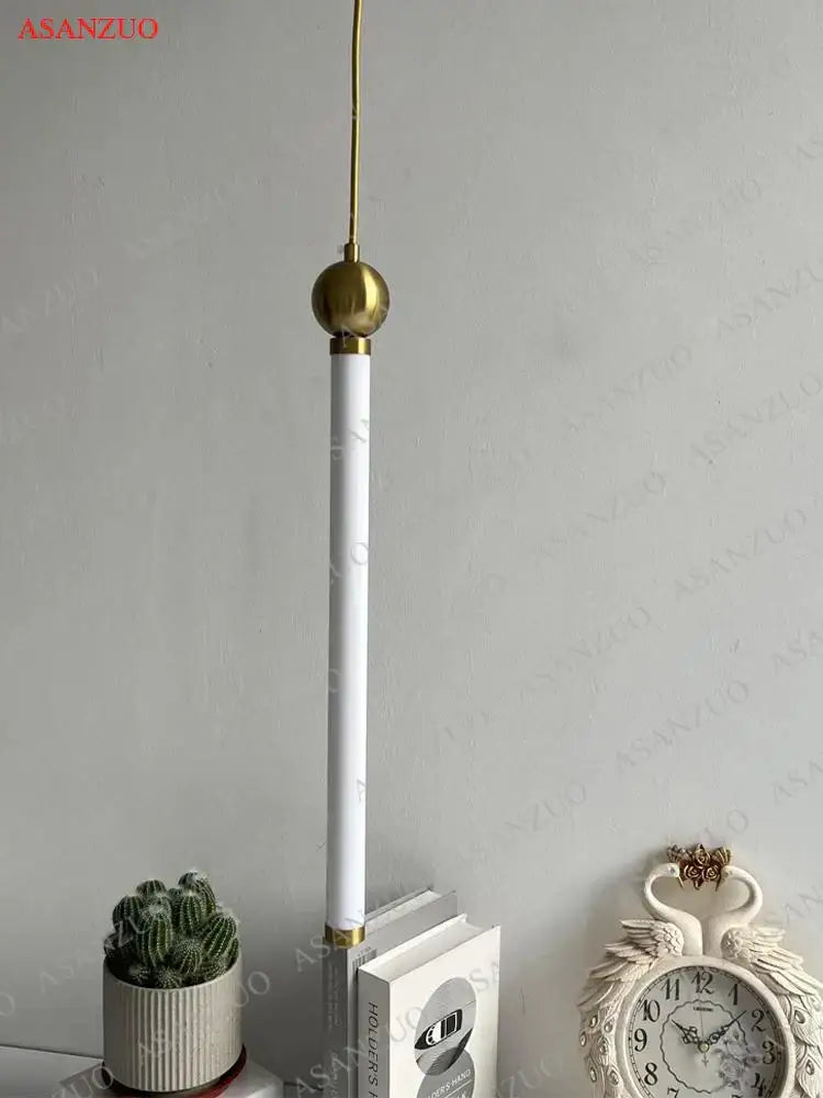 Minimalist gold led strip pendant light with polished brass spherical top and gold base ideal for dining room decorbites led strip pendant