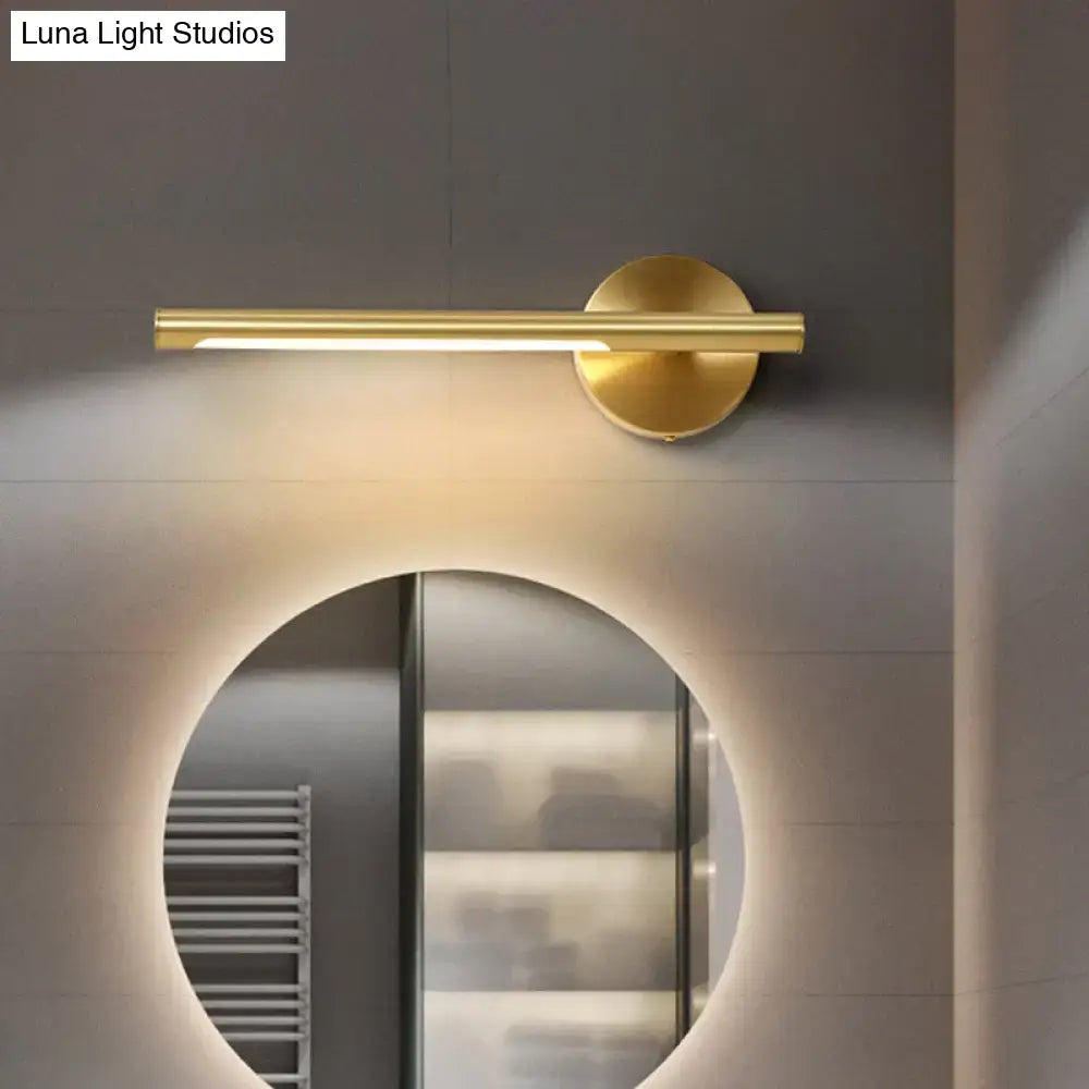 Minimalist gold wall light with acrylic diffuser featuring a modern cylindrical bar and circular base for bedroom use