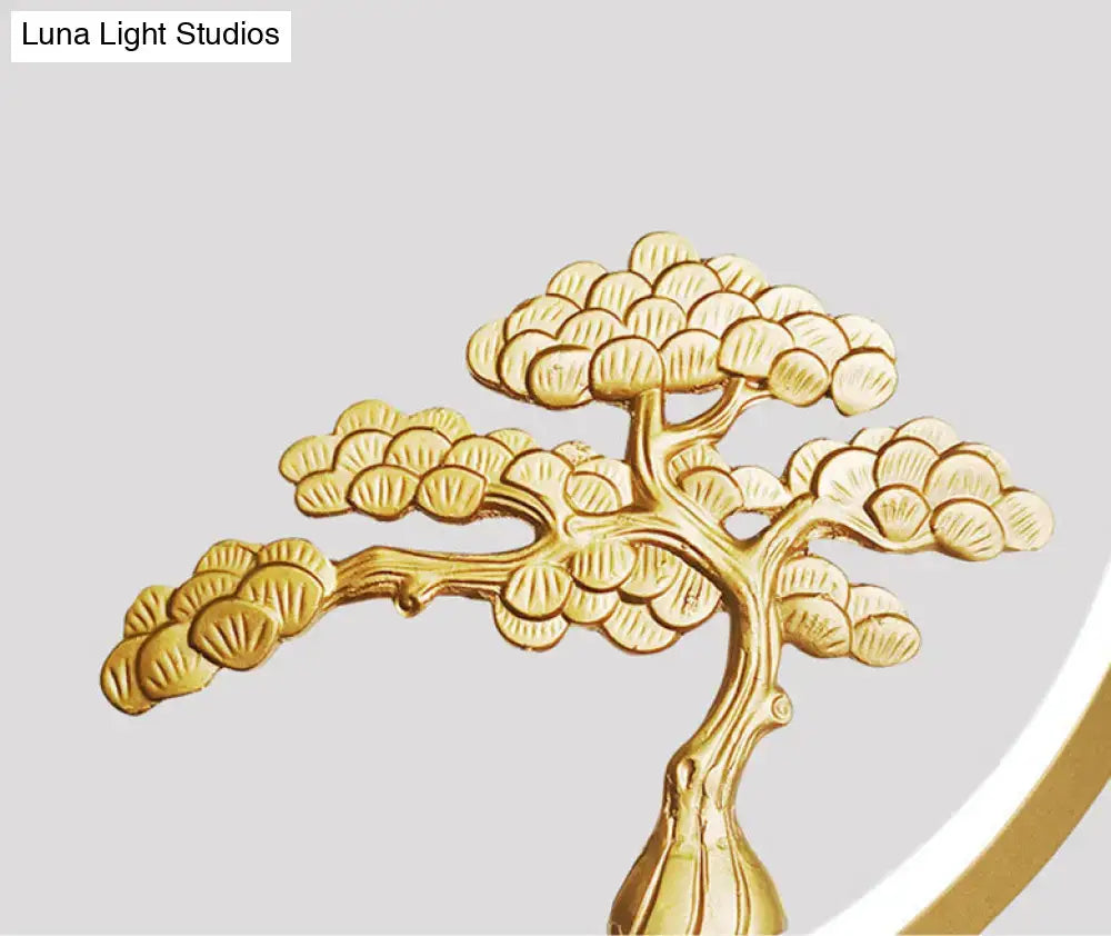 Minimalist gold metallic bonsai tree sculpture with detailed foliage and slender trunk for linear hanging lamp design