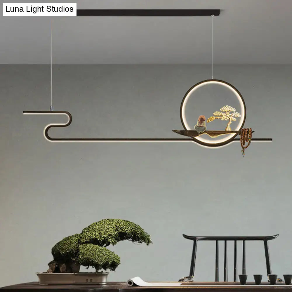 Modern minimalist linear hanging lamp with black frame and gold bonsai tree sculpture on floating platform