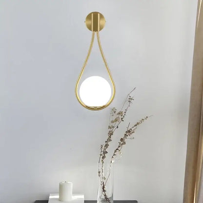 Minimalist gold-toned wall lamp with marble glass ball and circular frosted diffuser for living room decorbites glass ball