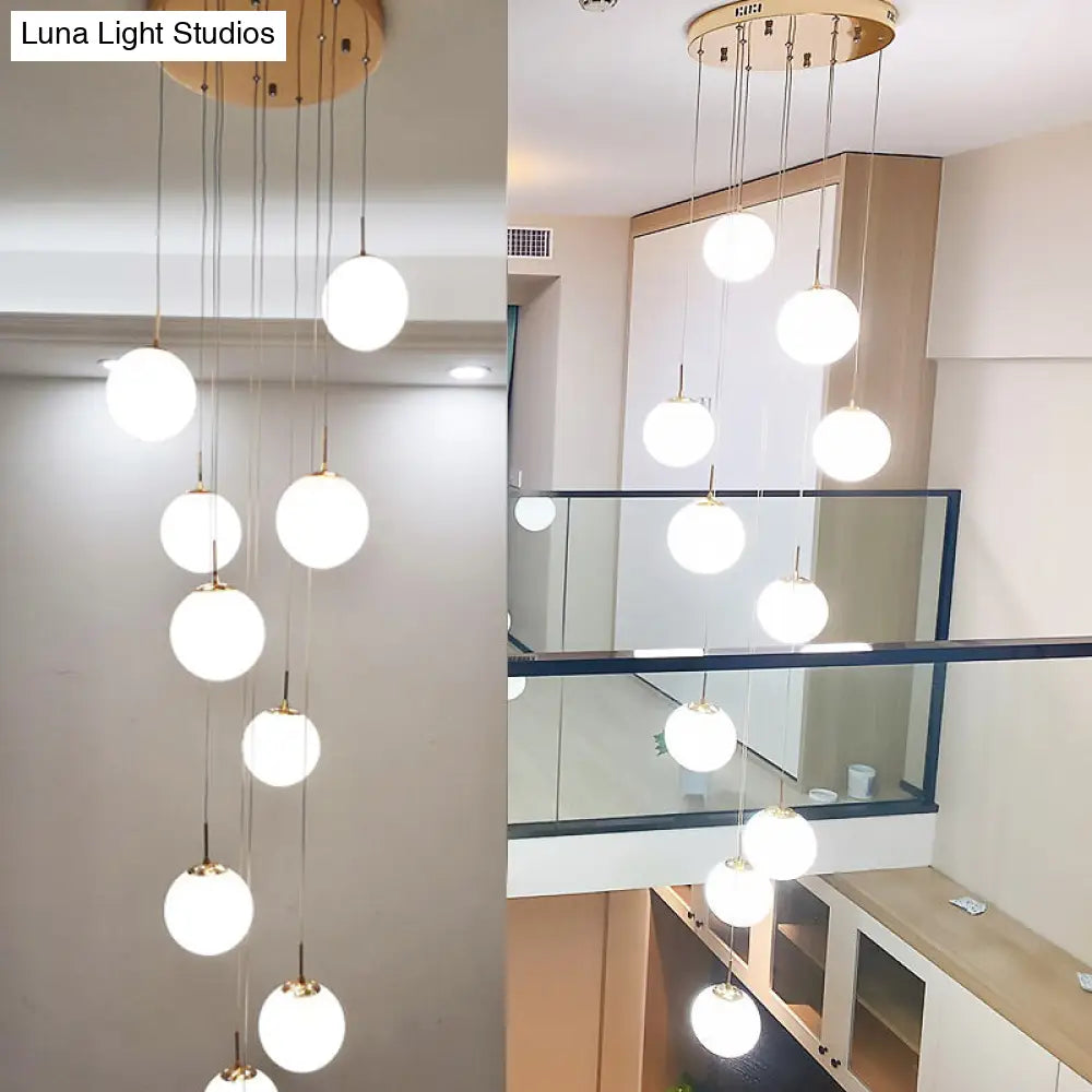 Minimalist Gold Multi-Pendant Ceiling Light with Cream Glass Bubbles and White Glass Staircase Suspension