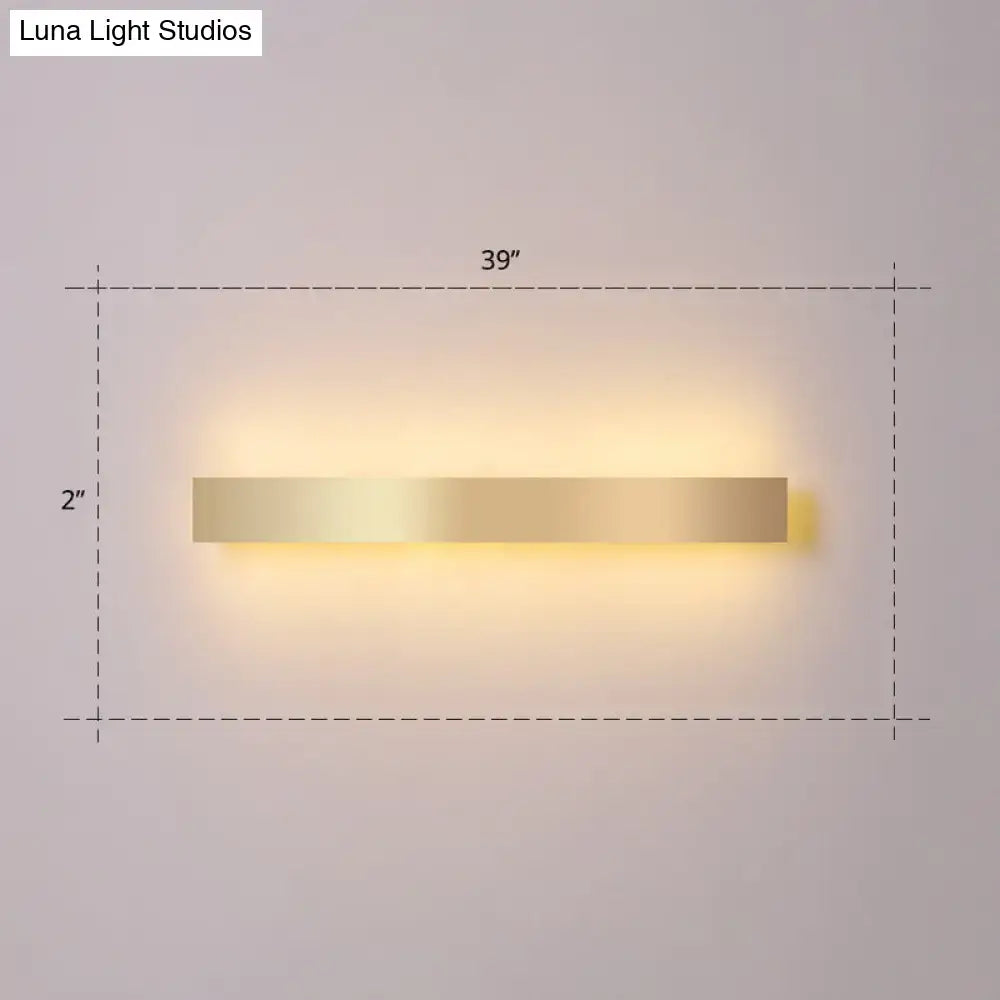 Minimalist gold plated led wall sconce with a sleek rectangular design and warm ambient lighting for living rooms