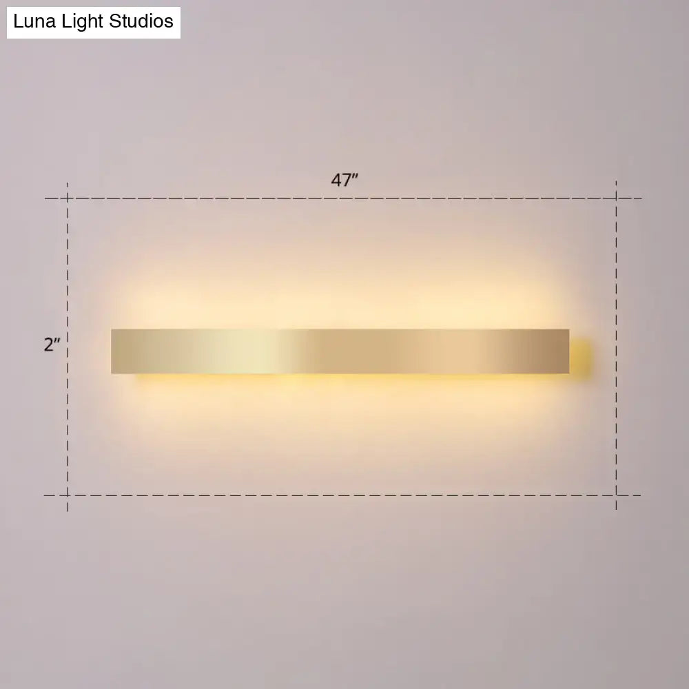 Modern minimalist gold plated led wall sconce with a sleek rectangular design and warm ambient lighting for living rooms