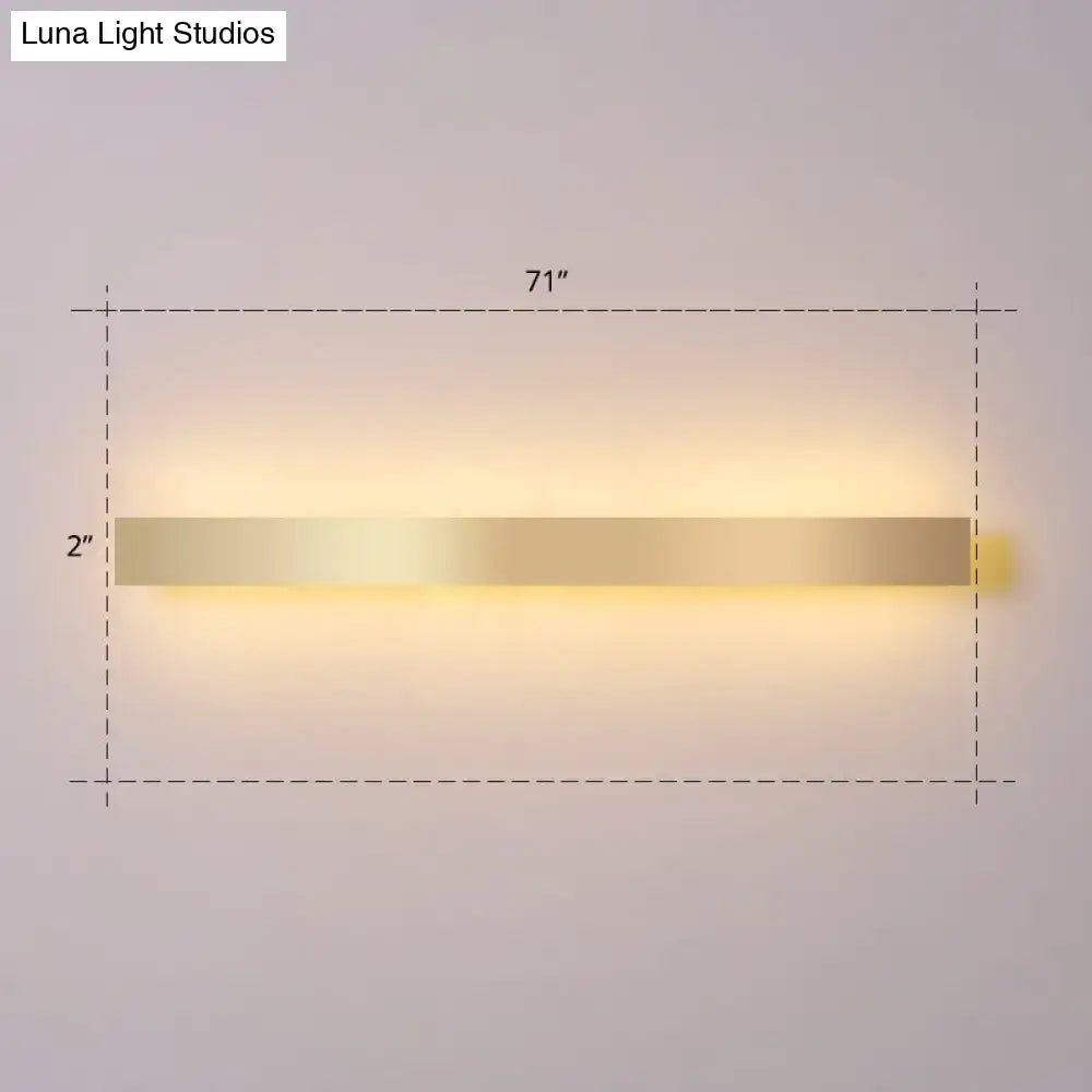 Minimalist gold plated led wall sconce with sleek rectangular design and warm ambient lighting for living room or bar