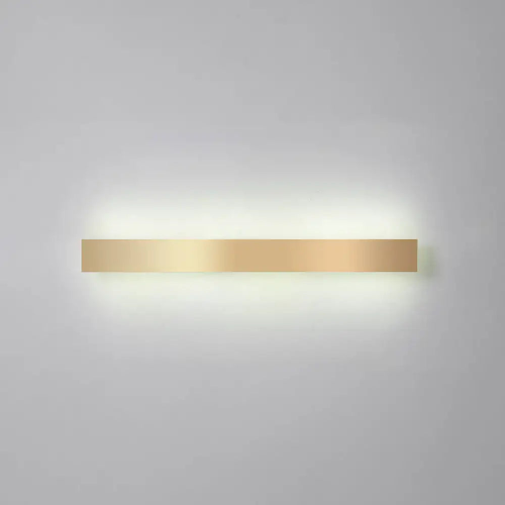 A sleek minimalist gold plated led wall sconce with a smooth metallic finish for living room or bar lighting