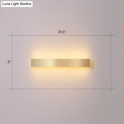 Minimalist gold plated led wall sconce with a rectangular design and warm ambient lighting for living room or bar