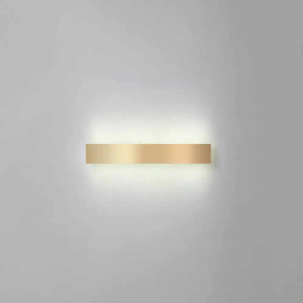 A sleek minimalist gold plated led wall sconce with a rectangular metallic finish for living room or bar lighting