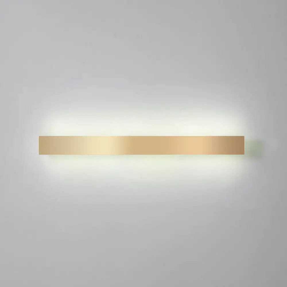 A sleek rectangular minimalist gold plated led wall sconce with modern design for living room or bar lighting