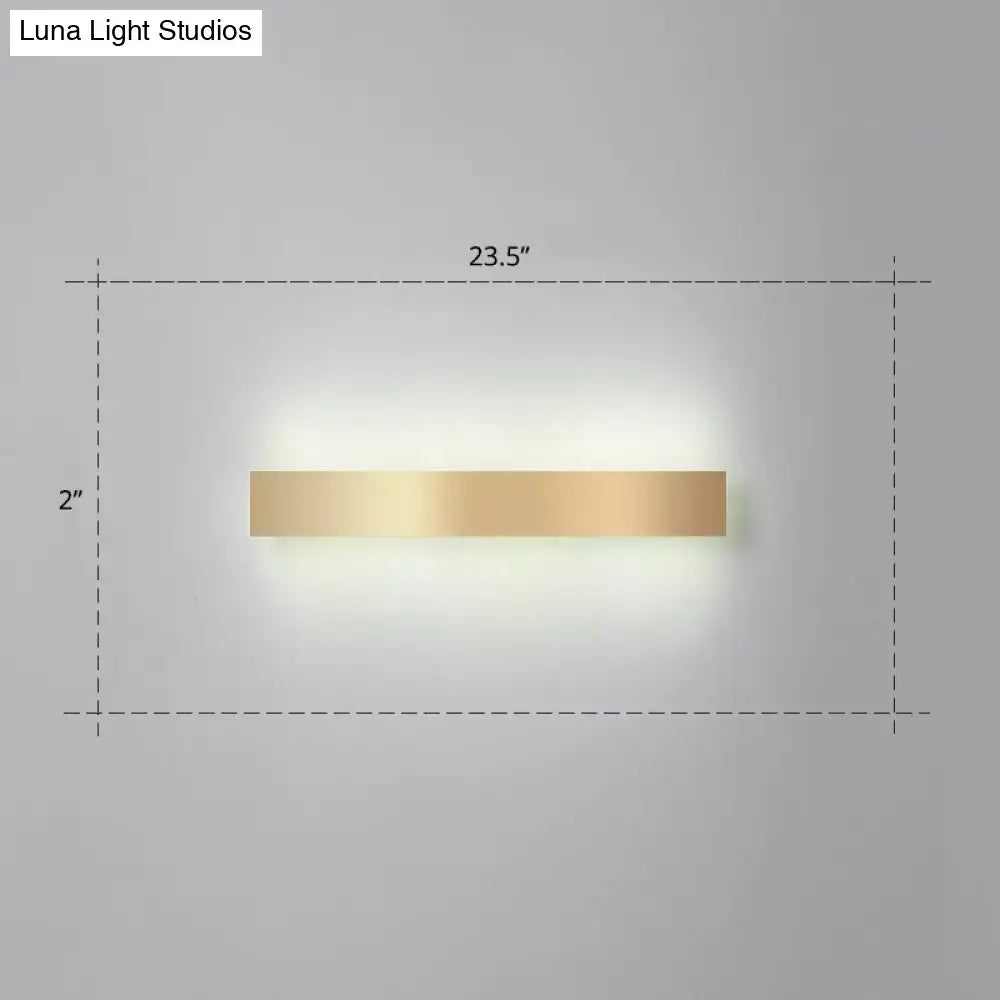 A sleek minimalist gold plated led wall sconce with a rectangular gold finish for living room or bar lighting