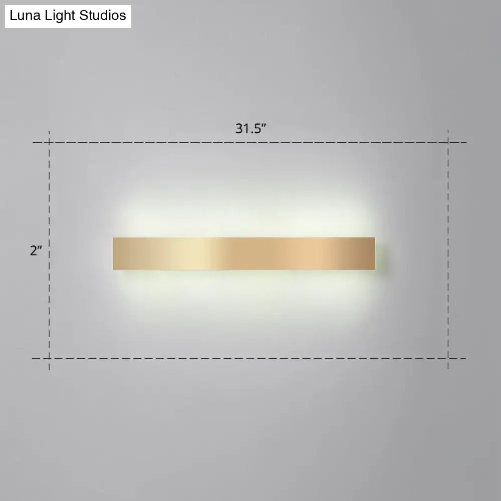 A sleek minimalist gold plated led wall sconce with a rectangular design for living room or bar lighting