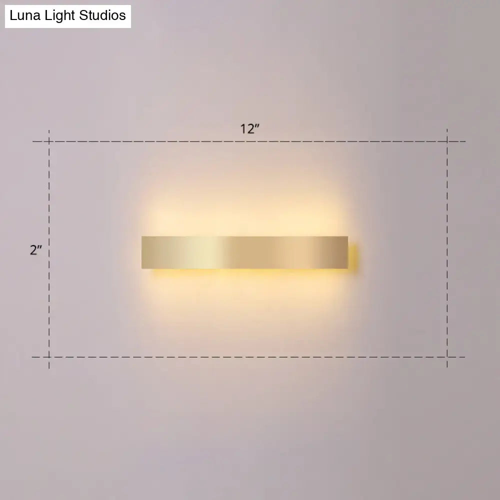A sleek minimalist gold plated led wall sconce with a rectangular gold finish for living room or bar lighting