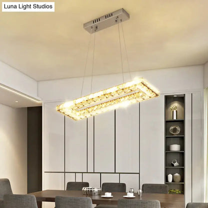 DecorBites minimalist rectangular led island pendant light with silver frame and clear K9 crystal accents emitting warm light