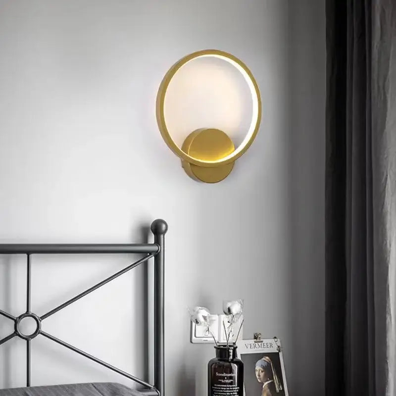 Minimalist gold ring led wall lights featuring a glowing circular sconce and illuminated disc for living room decor
