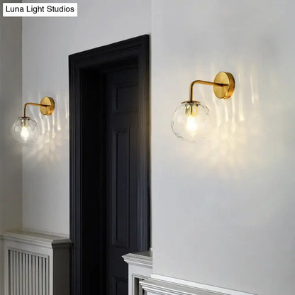 Gold-finished wall lamp with rippled clear glass sphere and faceted globe, DecorBites minimalist lighting fixture inches wide