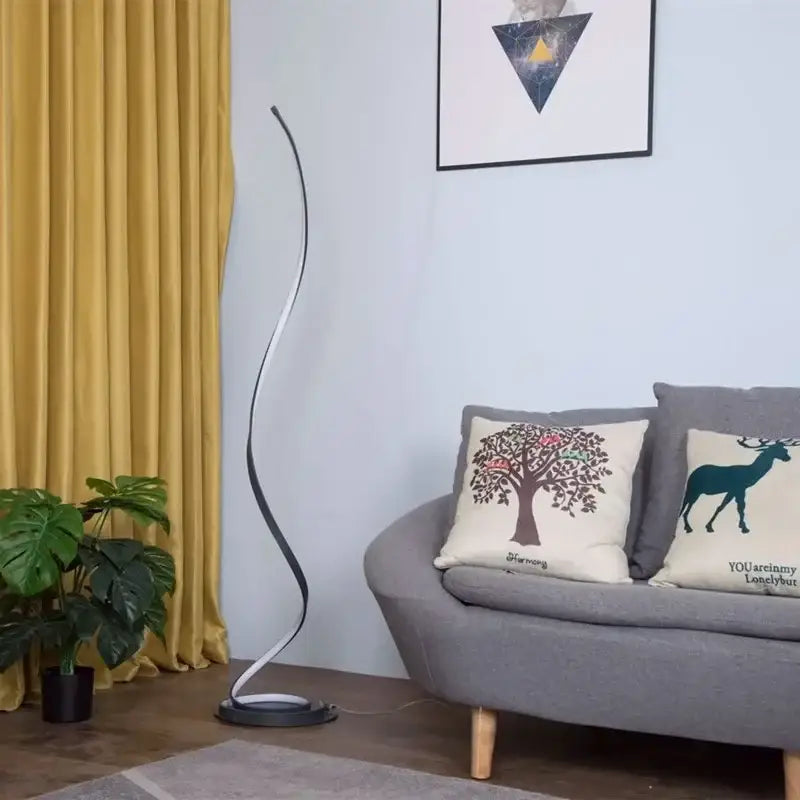 Modern black and silver minimalist standing lamp with curved design and warm led light strip for living room use