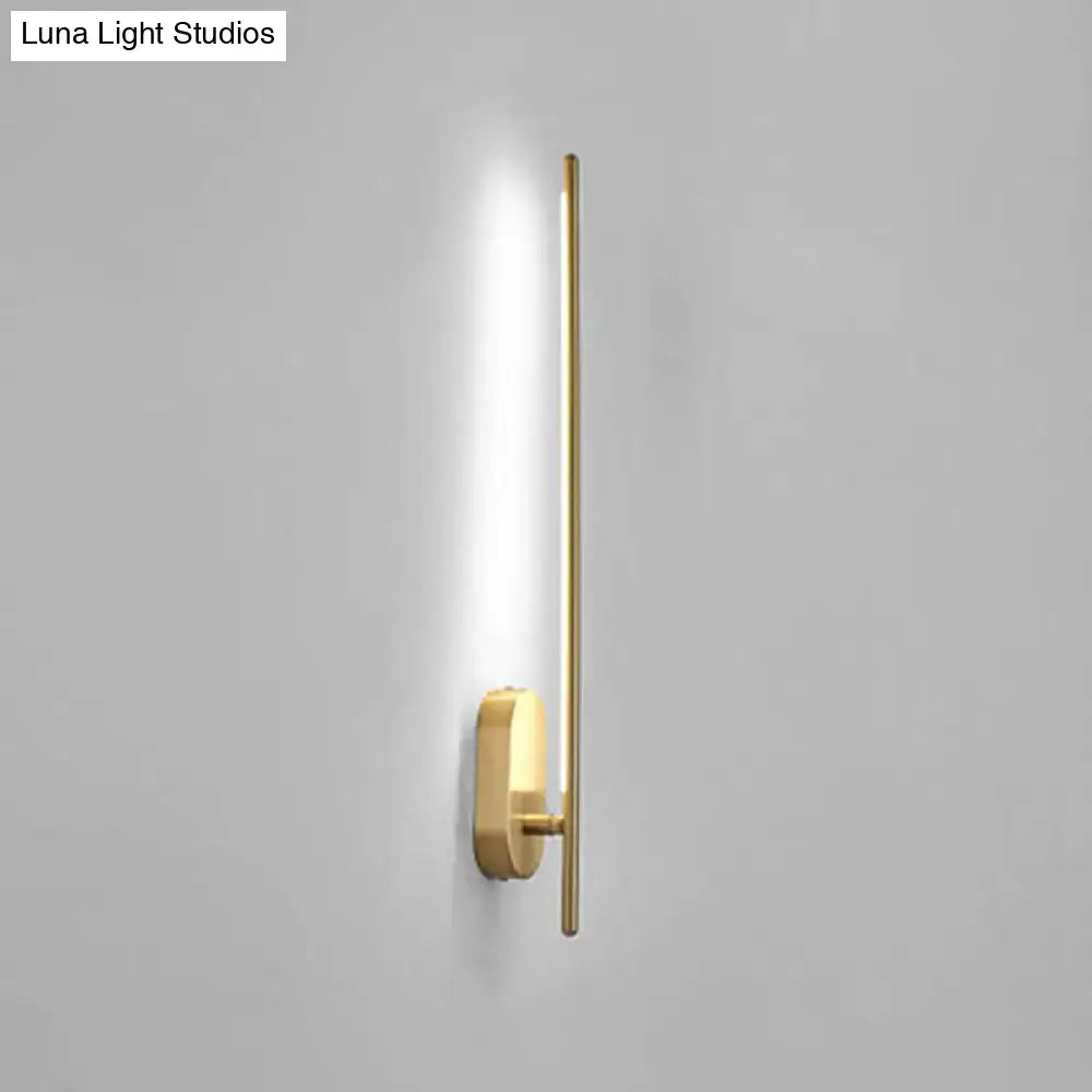 Minimalist gold vertical rod wall lamp with sleek elongated bar and rectangular base offers modern living room lighting