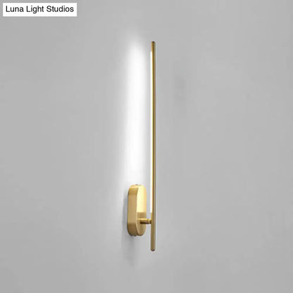 Minimalist gold vertical rod wall lamp with sleek elongated bar and rectangular base offers modern living room lighting