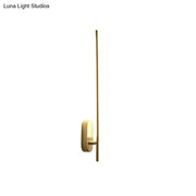 Minimalist gold wall lamp offers a sleek vertical rod design with a rectangular base for living room use