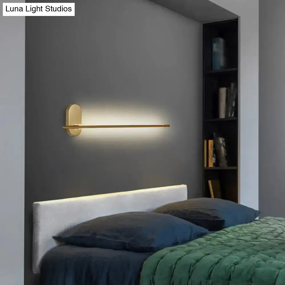 Minimalist gold wall lamp with a sleek horizontal bar offers softly diffused led lighting for living room use