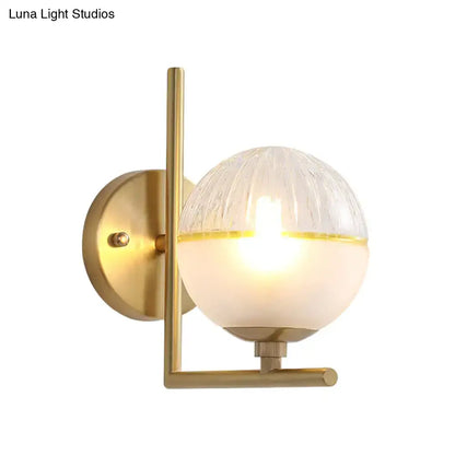 Brass-finished wall lamp with textured amber and frosted glass globe 8-inch fixture for minimalist bedroom lighting