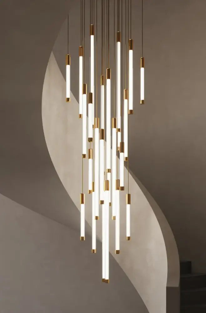 Minimalist gold and white elegant led chandelier featuring slender glowing tubes capped in polished gold for living room
