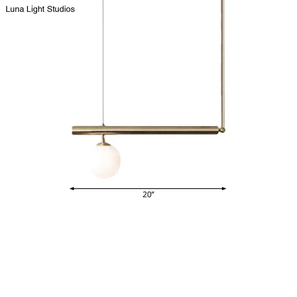 Minimalist brass pendant light with a spherical frosted glass bulb for dining room by DecorBites golden glass shade