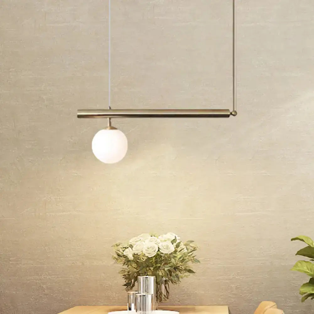 Minimalist brass pendant light with spherical frosted glass bulb from DecorBites™ for dining room chandelier