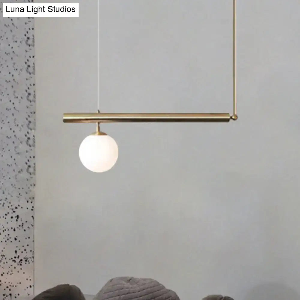DecorBites™ minimalist brass pendant light with frosted glass globe for modern dining room lighting