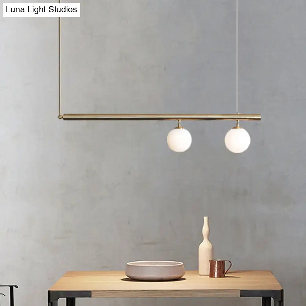 Modern brass pendant light with two white glass bulbs from decorbites for dining room use