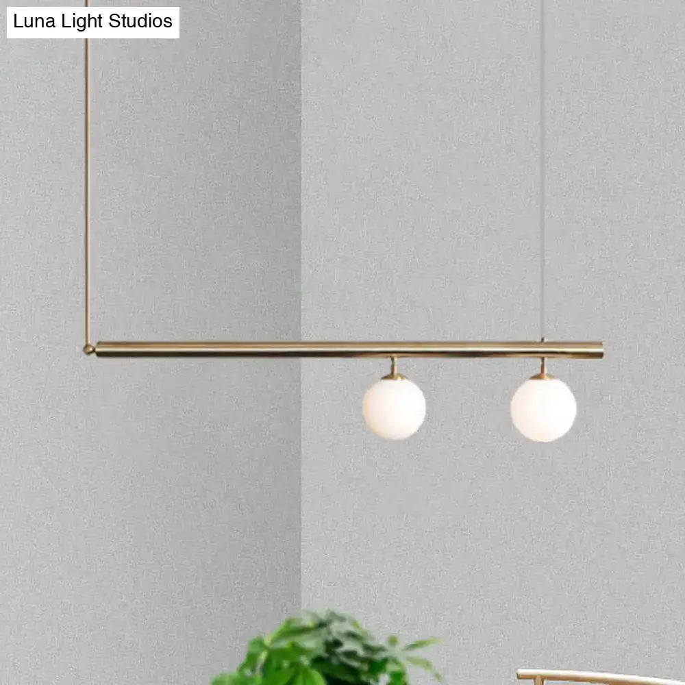 DecorBites™ modern brass pendant light with two white glass globes for dining room lighting