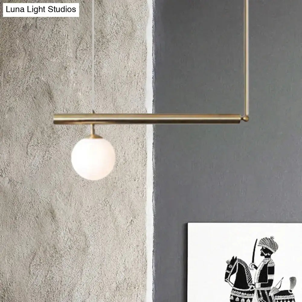 Modern brass pendant light with frosted glass globe bulb from DecorBites™ designed for dining room illumination