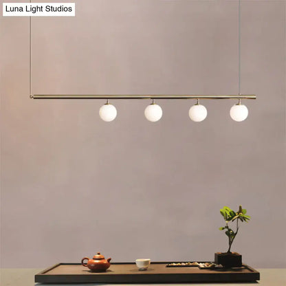 DecorBites™ modern minimalist pendant light with brass bar and frosted glass globes for dining room lighting