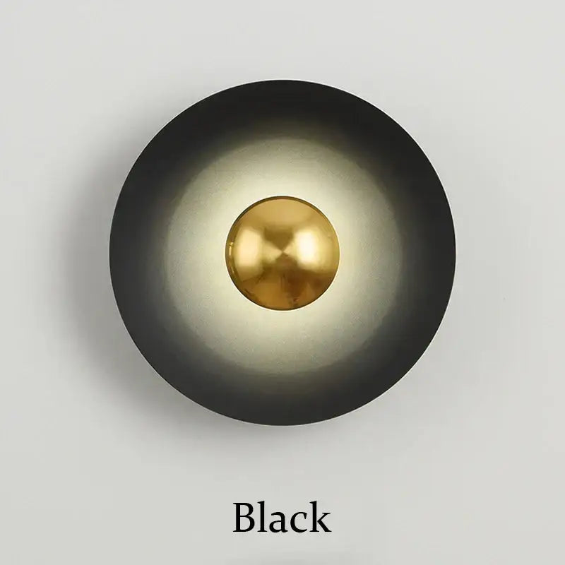 Minimalist black matte wall lamp with polished brass accent for bedroom ambient light by decorbites golden macaroon led