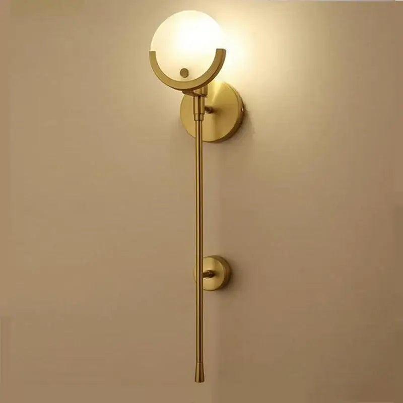 Minimalist golden marble wall lamp featuring gold-toned sconce with frosted glass globe for bedroom and living room decorbites golden marble
