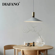 Minimalist gray and brass decorbites dimming pendant light with sleek modern design for dining room decor