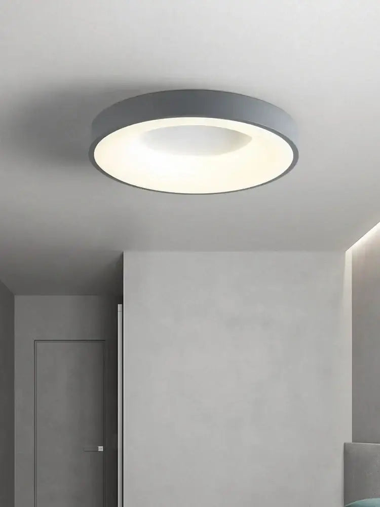Minimalist gray round dining ceiling lamp with a sleek frame and soft white illuminated center for dining room use