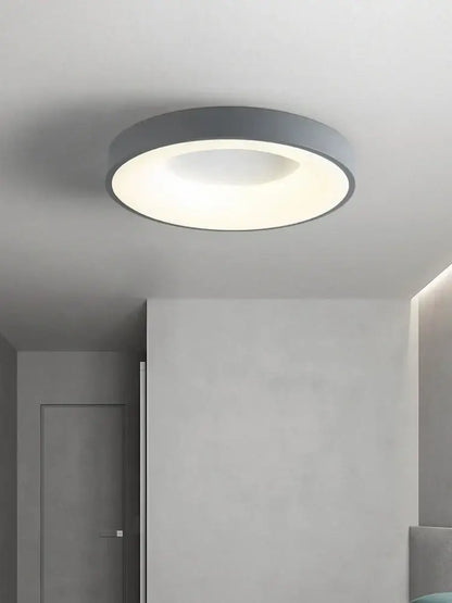 Minimalist gray round dining ceiling lamp with a sleek frame and soft white illuminated center for dining room use