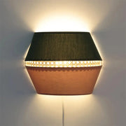 Hexagonal wall lamp with dark green fabric top, terracotta rattan base, illuminated woven band, direct wired electric