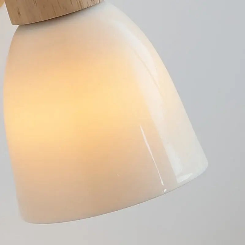 Cream-colored ceramic lampshade with natural wood top on decorbites iron wood led wall lamp with pull chain for bedroom decor