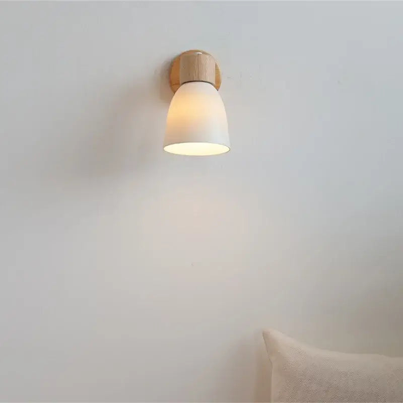 Minimalist iron wood led wall lamp with warm wooden base and matte white ceramic shade for bedroom decorbites iron wood style
