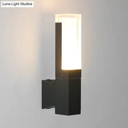 Minimalist led black wall lamp with rectangular frosted glass diffuser emitting warm white light for courtyard use