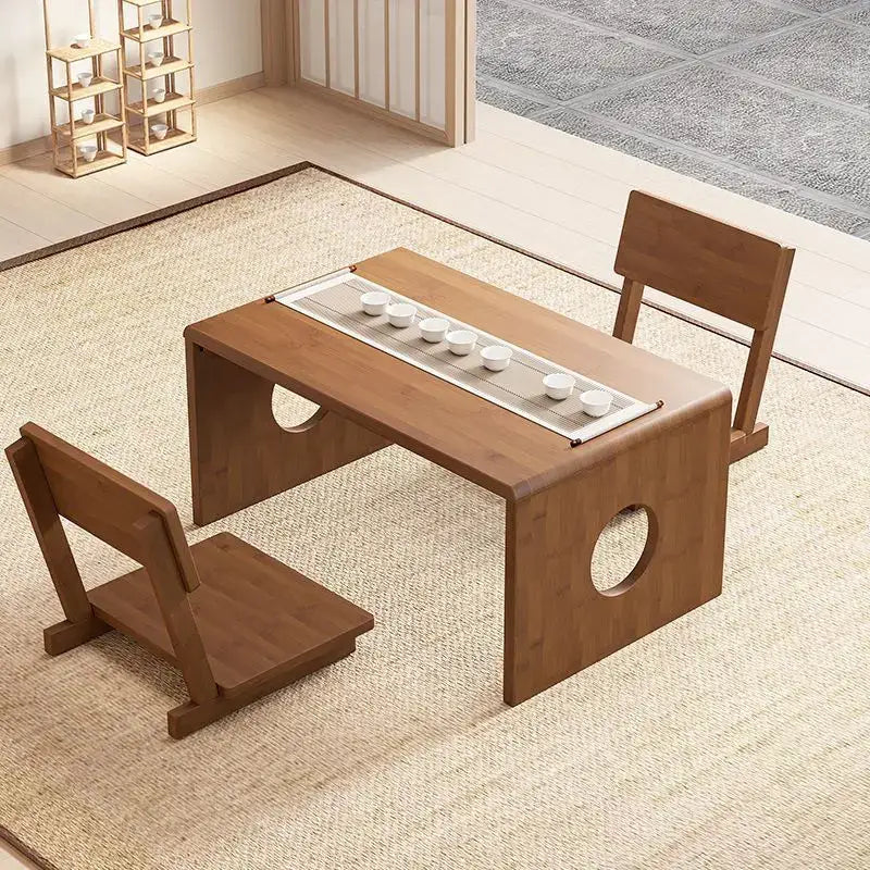Minimalist light brown bamboo folding table with circular cutouts and built-in tray holding six white ceramic cups