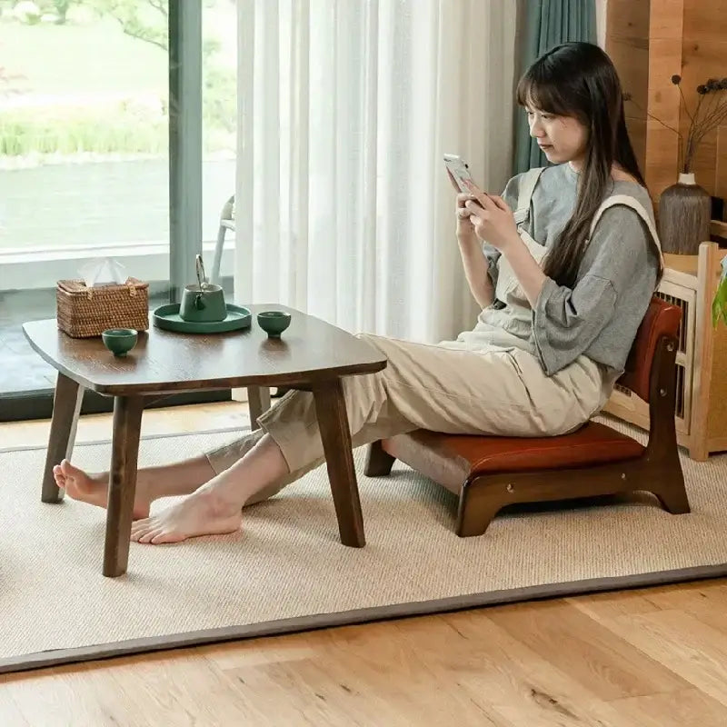 Dark wood low table with angled legs and rectangular top complementing minimalist light gray decorbites legless tatami chair