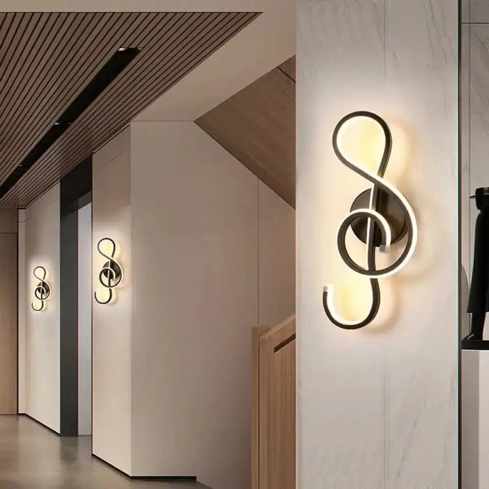 Modern black metal minimalist line art sconce light fixture shaped like a treble clef for hallway lighting
